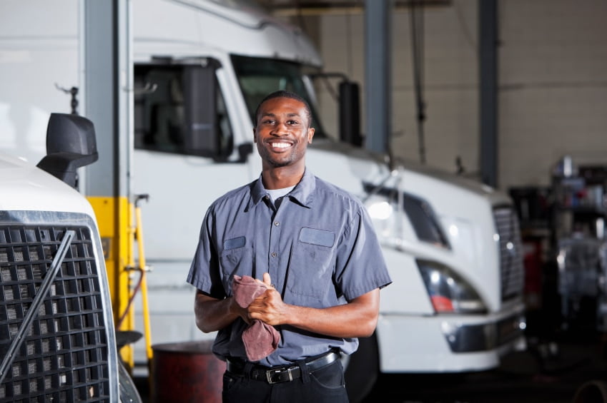 Mechanic in garage with semi-truck