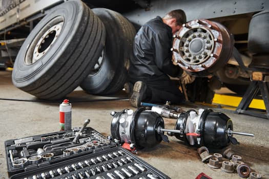 man working on truck wheel