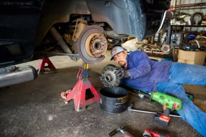 heavy-duty auto mechanic working on brakes